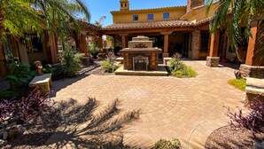 A courtyard with a fountain, stone walls, and tropical plants. -  Heated resort pool , jacuzzi, out door sound system, secluded courtyard.<br> (Scottsdale)