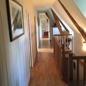 Stroll down this charming hallway to a fully equipped kitchen area.