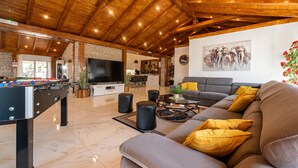 A spacious living area with a pool table, sofa, and a television. - Beautiful home in Turanj with sauna (Turanj)