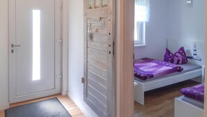 A bedroom with a bed, a window, and a door. - 2 bedroom awesome home in Behrenhoff (Behrenhoff)