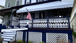 A building with a sign reading "The Blue Whale" and a white awning.