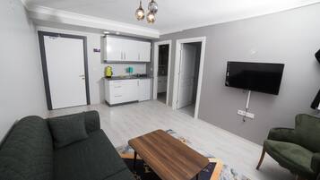 Family Suite, 2 Bedrooms | Living area | 32-inch LCD TV with satellite channels, TV