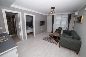 Deluxe Room, 1 Bedroom | Living area | 32-inch LCD TV with satellite channels, TV