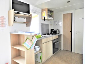 Enjoy cooking in this kitchen with appliances, a sink, and a window above the counter.