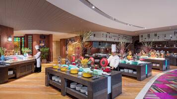 A buffet setup with multiple food stations, chefs, and a variety of dishes.