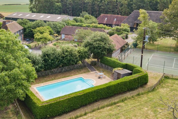 A residential area with a swimming pool surrounded by well-maintained hedges and a tennis court. - Great Higham Barn by Bloom Stays -  sleeps 26 guests  in 7 bedrooms (Sittingbourne)
