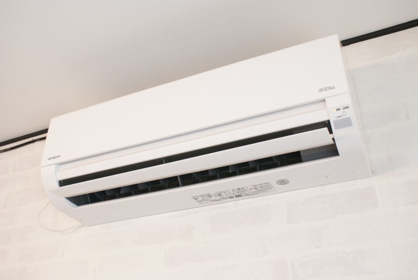 A white air conditioning unit mounted on a wall.