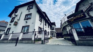 A building with a sign reading "PENSIUNEA" and a gated entrance. - Pensiunea Luiza (Brasov)