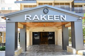 The entrance to a building with a sign reading "RAKEEN".