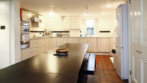 A modern kitchen with a large island, built-in appliances, and ample counter space. - NO LONGER AVAILABLE FOR RENTAL (Kemptown)