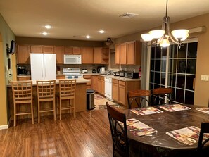 Enjoy cooking and dining in this well-lit kitchen with a central island, microwave, and stainless steel range.