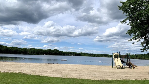 A beach with a playground and a lake. - Gorgeous Villa in Pocono nr Ski Slopes, Camelback, Kalahari w Games Rm & Hot tub (Pocono Summit)