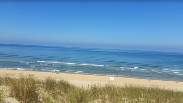 A beach with clear skies and calm waters.