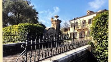 Enter a traditional estate through a beautifully crafted iron gate and stone archway.
