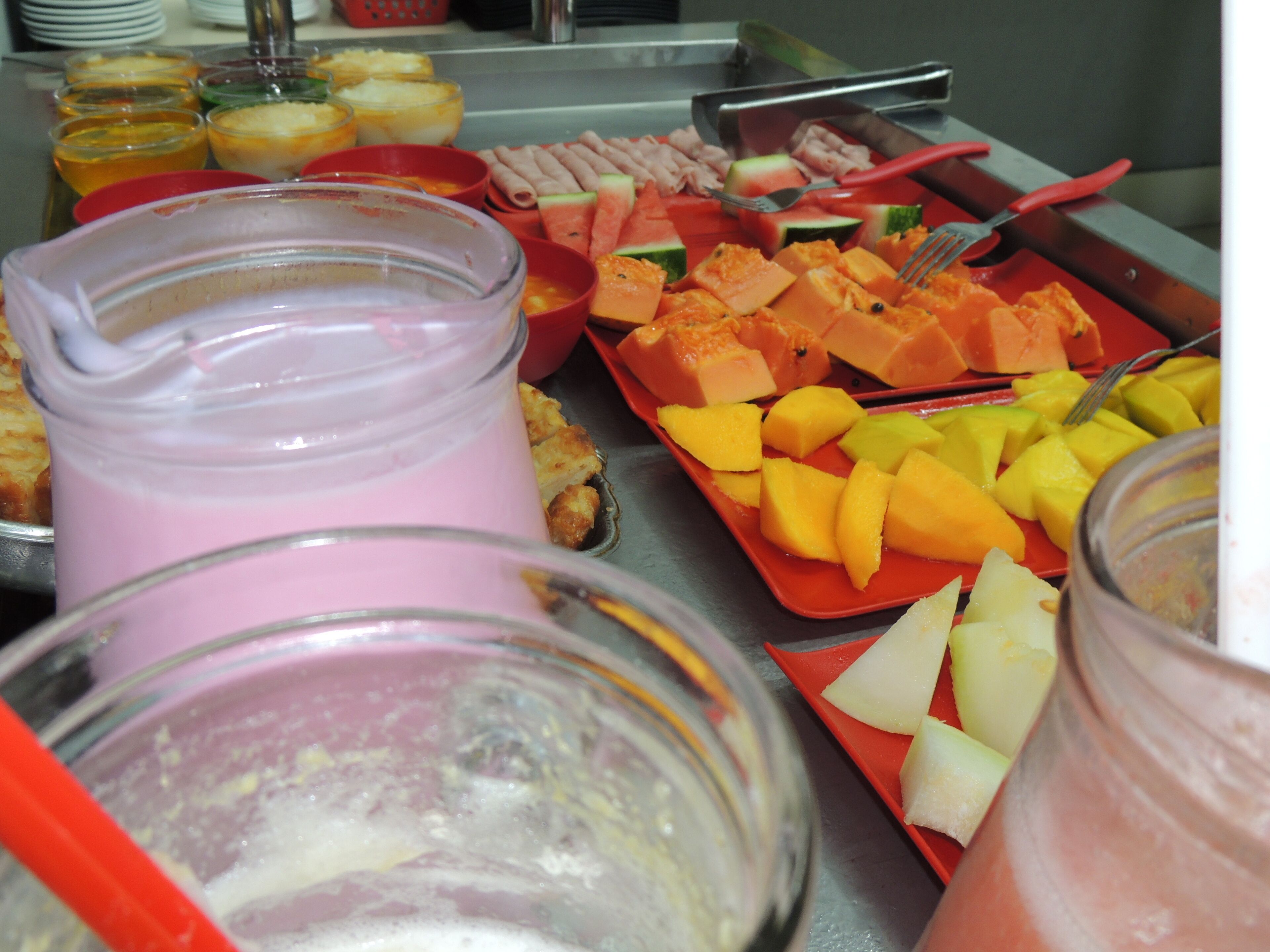 A buffet with various food items and beverages.