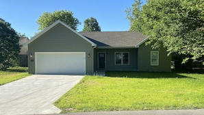 A single-story house with a garage, a front yard, and a driveway. - Great new home - just for you! (Newburgh)