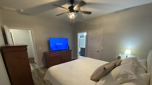 A bedroom with a bed, a dresser, a television, and a ceiling fan. - Great new home - just for you! (Newburgh)