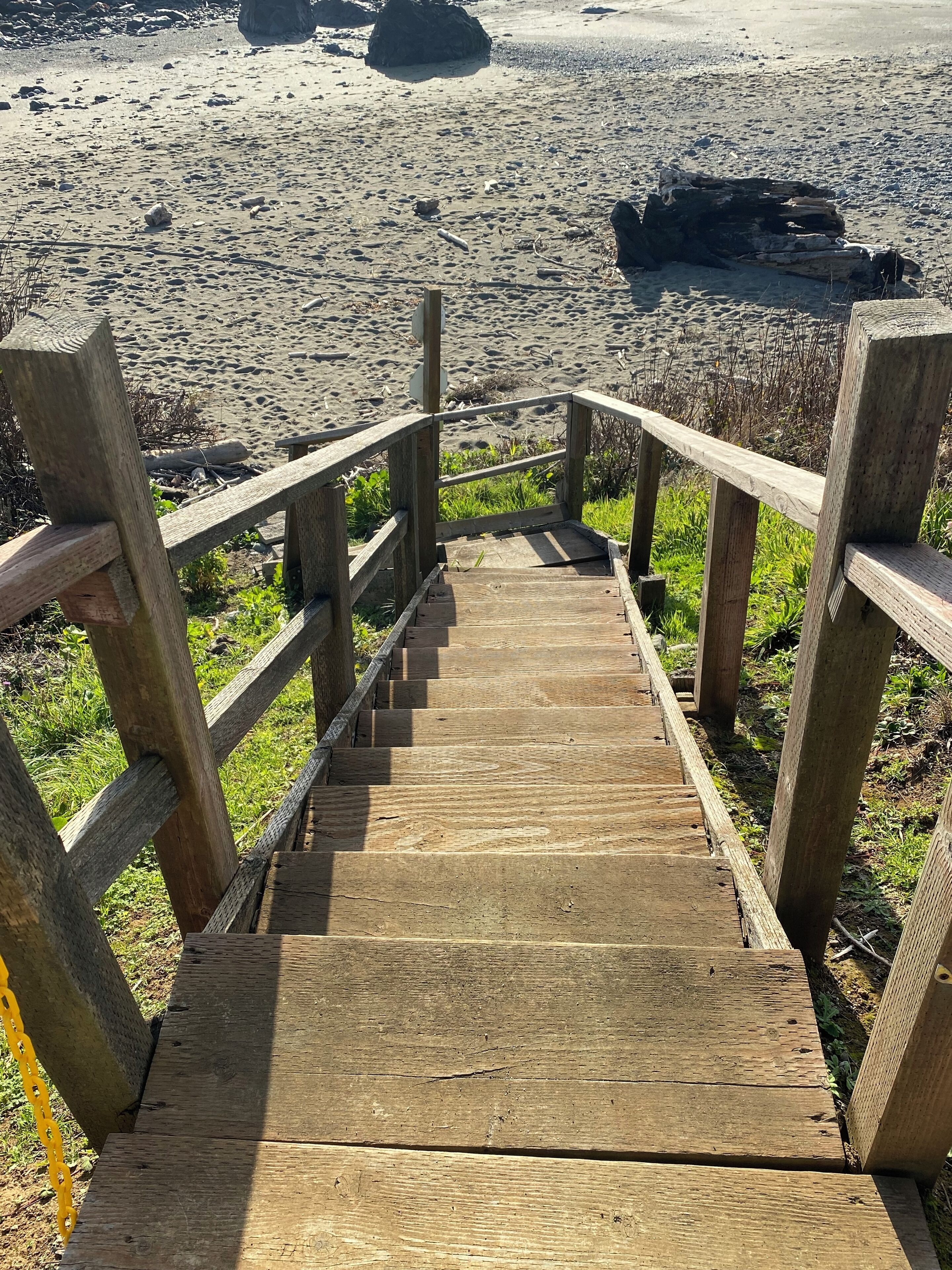 A wooden staircase leading to a beach.