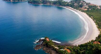 Beachfront Condo with Warm, Rustic Interiors & Direct Access to Playa Flamingo