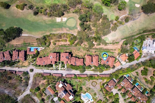 A residential area with houses, a swimming pool, and a golf course.