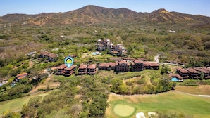 A resort with multiple buildings, a golf course, and terraced gardens. - Recently Renovated Luxury Condo with Resort-Style Beach Club Access and Ocean Views (Cabo Velas)