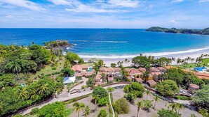 A coastal resort with villas, a beach, and a clear view of the ocean. - Stunning Luxury Mansion in Playa Flamingo with Six Bedrooms and Beachfront Access (Cabo Velas)