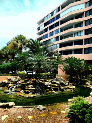 Experience the tranquil atmosphere of our hotel, surrounded by lush tropical plants and a serene waterfall.
