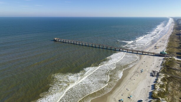 A pier extending into the ocean with a beach on one side. - Surf Park House – Historic Jax Beach Home, 3 Blocks to Beach, Pet Friendly (Jacksonville Beach)