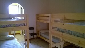 A dormitory room with bunk beds, a small chair, and a window. - Self-catering single room for rent with a private bathroom (Marina di Montenero di Bisaccia)