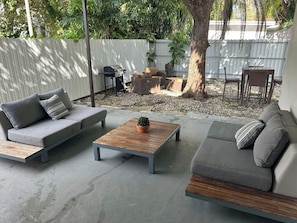 A patio with two sofas, a coffee table, and a small potted plant. - Near Beaches downtown Renovated  large  3/2  one story  townhouse  "Casa Mango " (Miami)