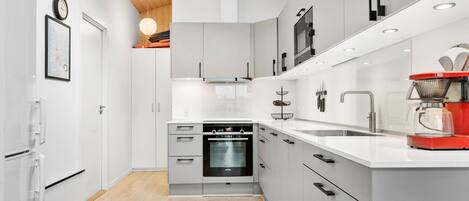 Fridge, stovetop, dishwasher, coffee/tea maker