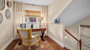 A room with a desk, chair, and a window with curtains. - Casa DeSoto - Luxury Downtown Oasis (St. Augustine)