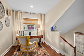 A room with a desk, chair, and a window with curtains. - Casa DeSoto - Luxury Downtown Oasis (St. Augustine)