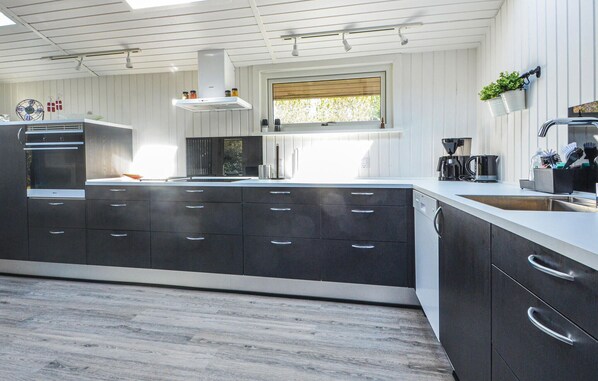 Fridge, stovetop, dishwasher, coffee/tea maker