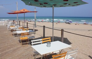 A beachside restaurant with outdoor seating and a view of the ocean. - Gorgeous apartment in Torrevieja (Torrevieja)