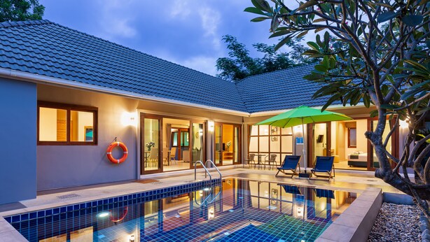 A modern house with a swimming pool, outdoor seating, and a well-lit interior. - Lady Naya Villas (Rawai)