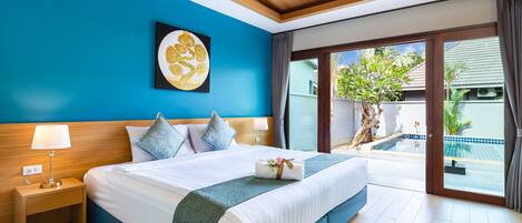 A hotel room with a large bed, a nightstand, a wall art piece, and a view of a swimming pool.