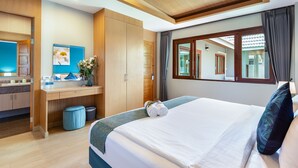 A modern hotel room with a large bed, a wooden wardrobe, a bathroom, and a view of the outside. - Lady Naya Villas (Rawai)