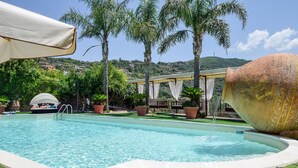 A swimming pool with a clear blue water, surrounded by palm trees and a white canopy. - Nice home in Laureana Cilento (Laureana Cilento)