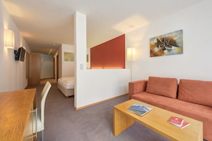 Junior Suite | Living area | Flat-screen TV, heated floors