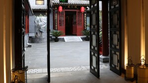 A traditional entrance with a wooden ceiling and lanterns. - True Go Hotel (Beijing)
