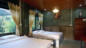 A room with two beds, a wooden ceiling, a window with curtains, a painting on the wall, and a wooden cabinet. - Rattikanchana Resort (Mae Fa Luang)