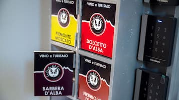 Un muro con diversi cartelli per 'VINO e Turismo' e 'La Grotte del Lupo', e una telecamera di sicurezza HIKVISION.