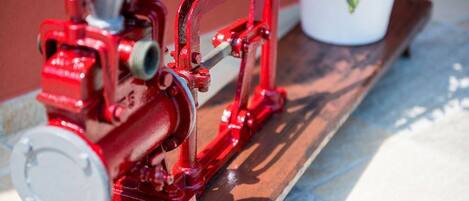 A red mechanical device on a wooden surface.