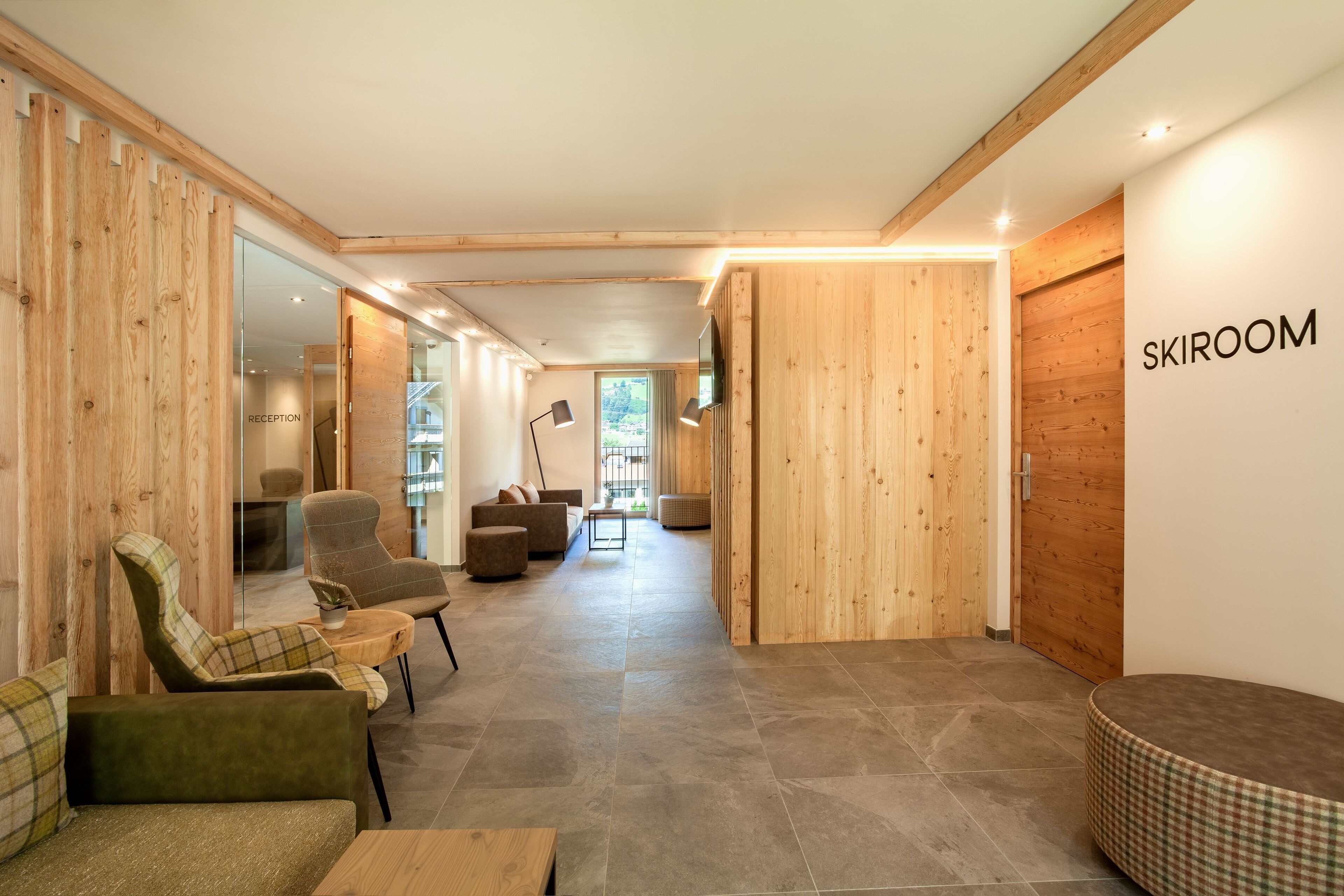 A modern reception area with wooden walls, a reception desk, and seating arrangements.