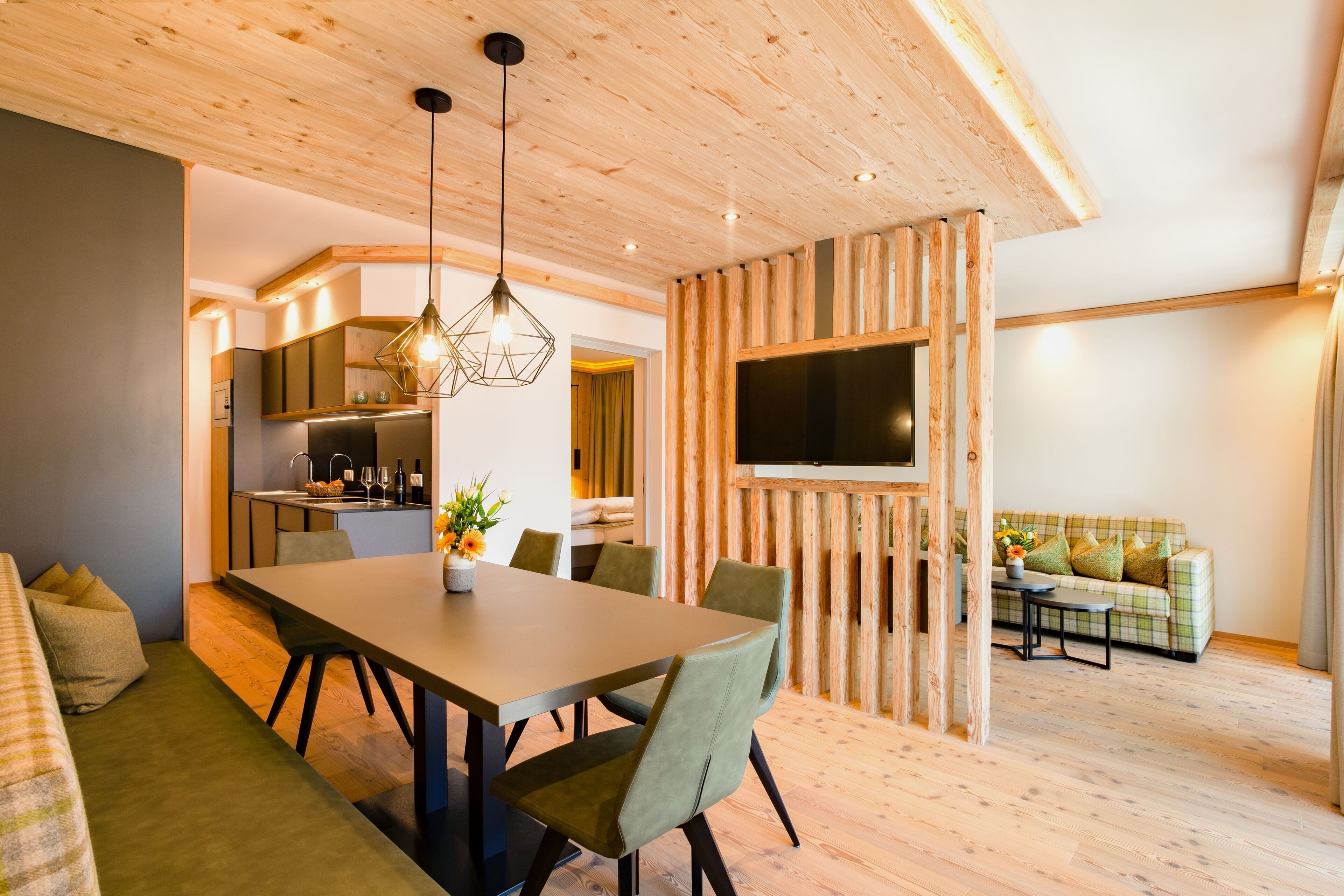 A modern interior with a dining area, kitchen, and living space.