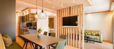 A modern interior with a dining area, kitchen, and living space.