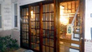 A building with a large wooden door with glass panels, a welcome sign, and a small step leading to the entrance. - Quiet neighborhood near beaches, bayou and historic downtown Ocean Springs. (Ocean Springs)