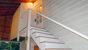 A staircase with white steps and wooden handrails leading to a second-floor landing. - Quiet neighborhood near beaches, bayou and historic downtown Ocean Springs. (Ocean Springs)