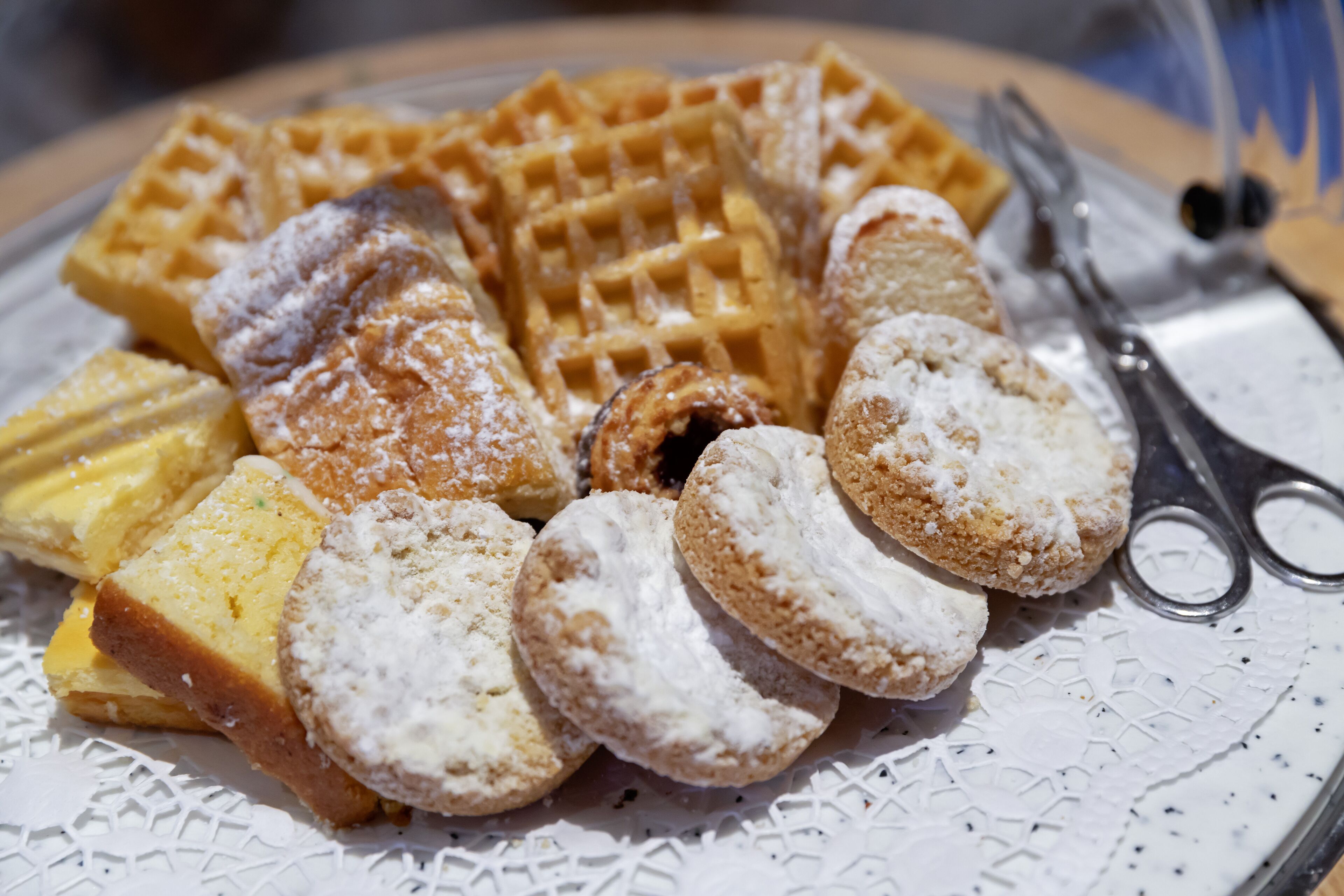 A plate with waffles, pastries, and a fork.